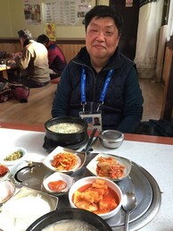 Enjoying a typical Korean meal.